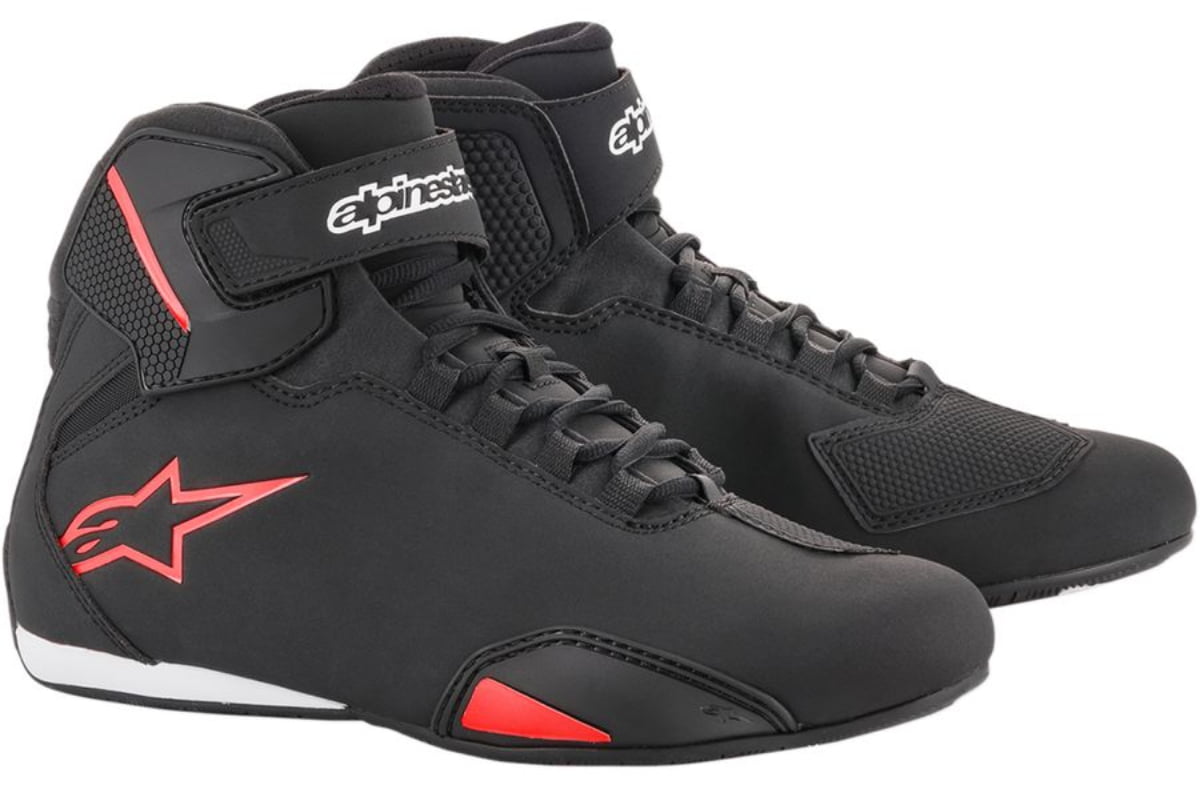 Black and white Alpinestars Sektor shoes with neon-red accents, featuring a sleek design, lace-up front, and a Velcro strap for secure fit, size 12 US.