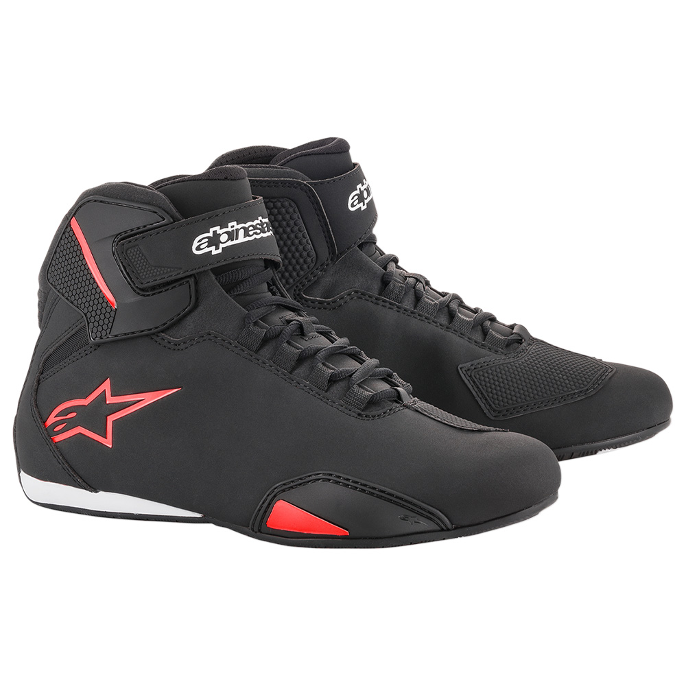 Black and white Alpinestars Sektor shoes with neon red accents, featuring a sleek design, high-top silhouette, and adjustable strap for secure fit, size 10 US.