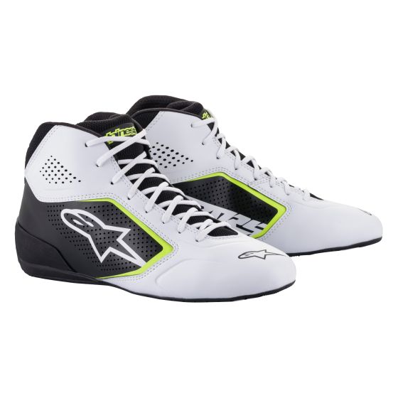 Black and white kart boots with fluro yellow accents, featuring a sleek design, breathable perforations, and a prominent Alpinestars logo on the side.