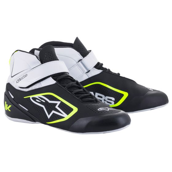 Black and white kart boots with fluro yellow accents, featuring a high-top design, Velcro strap, and reinforced toe, ideal for racing performance, size UK 9.5 / EUR 43.5.