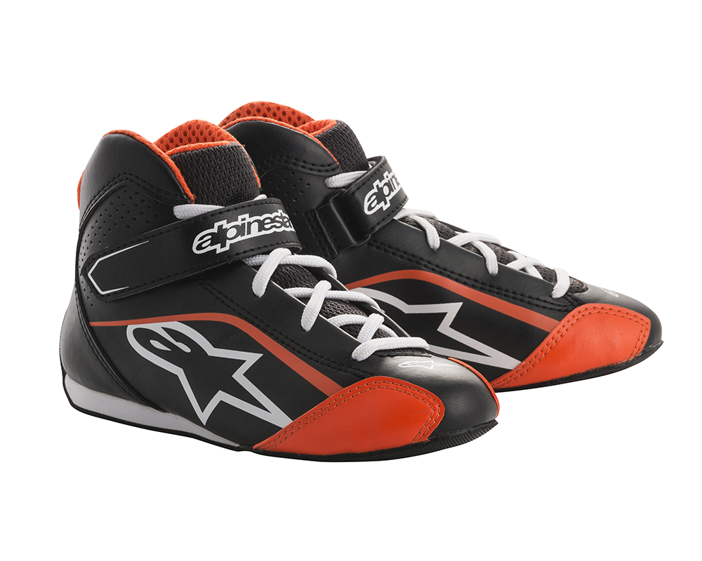 Black and white kart boots with fluro yellow accents, featuring a high-top design, padded collar, adjustable strap, and rubber sole, sized UK Childs 11.5 / Eur 30.