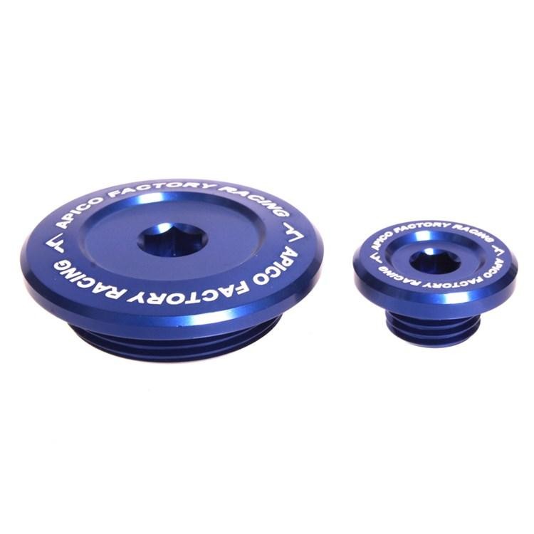 Blue anodized aluminum engine plugs by Apico, featuring a smooth, rounded design with engraved "Apico Factory Racing" text, suitable for Yamaha YZF and WRF models.
