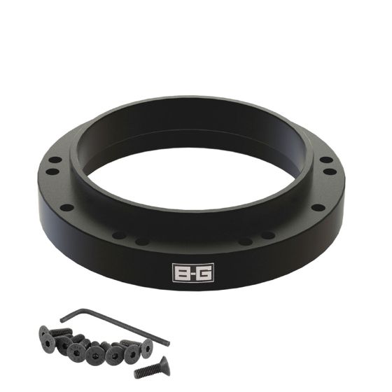 Black aluminum steering wheel spacer from B-G Racing, featuring multiple mounting holes and accompanied by screws and an Allen wrench for installation.