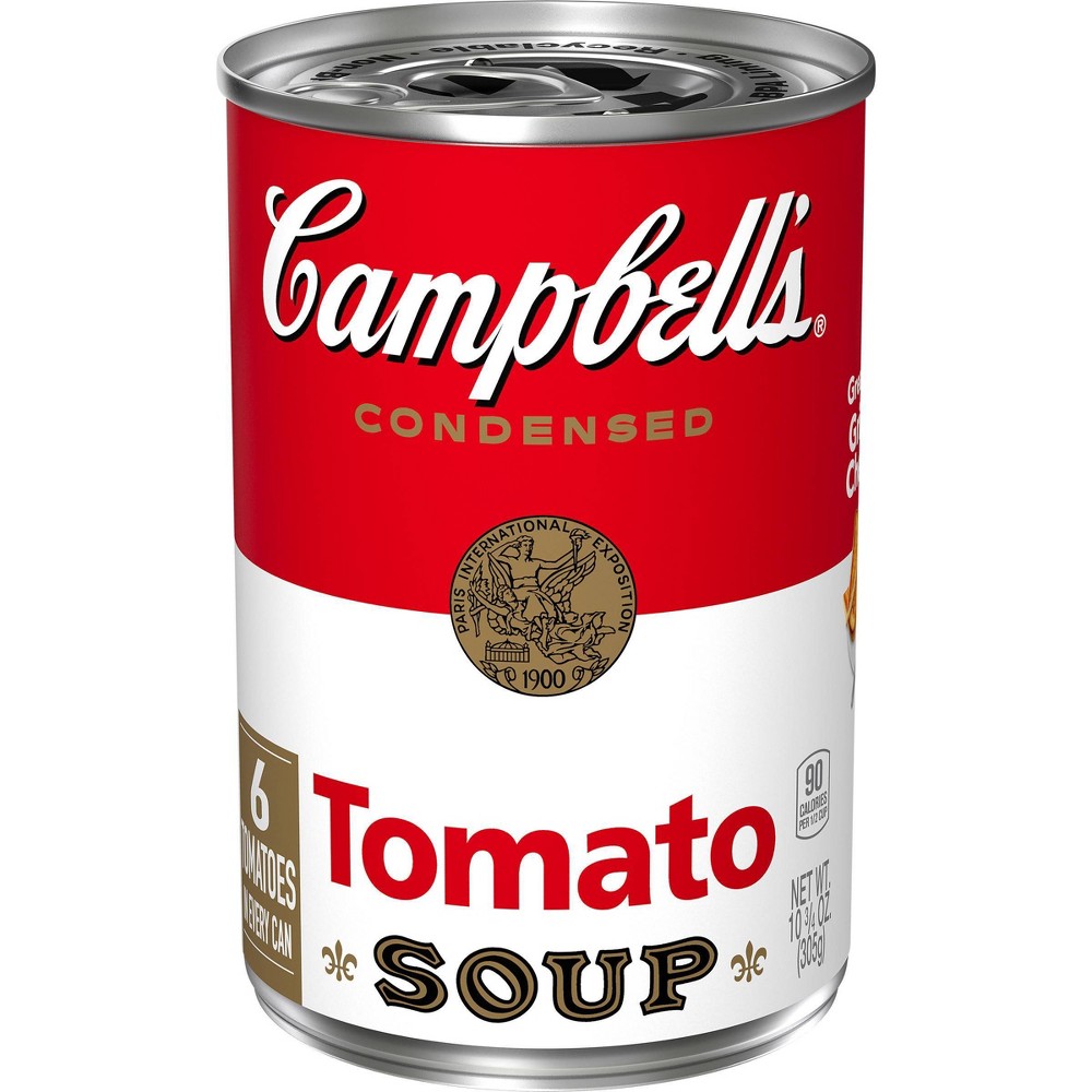 Red and white metal can of Campbell's Condensed Tomato Soup, 10.75 oz, featuring the iconic logo, nutrition facts, and a vintage seal, with a pull-tab lid.