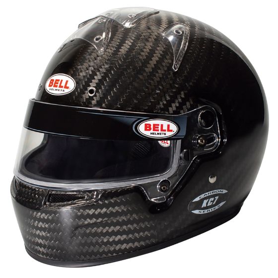 Black carbon fiber kart helmet with a glossy finish, featuring a clear visor, ventilation slots, and distinctive Bell logo stickers, sized at 54cm.