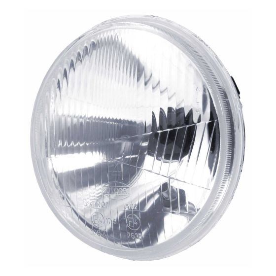 Round, clear halogen headlight unit with a reflective silver interior, designed for 7" left dip applications, featuring a ribbed lens for light distribution.