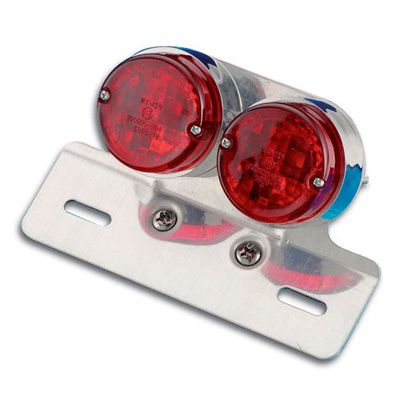 Chrome-finished metal bracket with two round red LED lights, designed for rear mounting on bikes, featuring a sleek, reflective surface and a sturdy mounting plate.