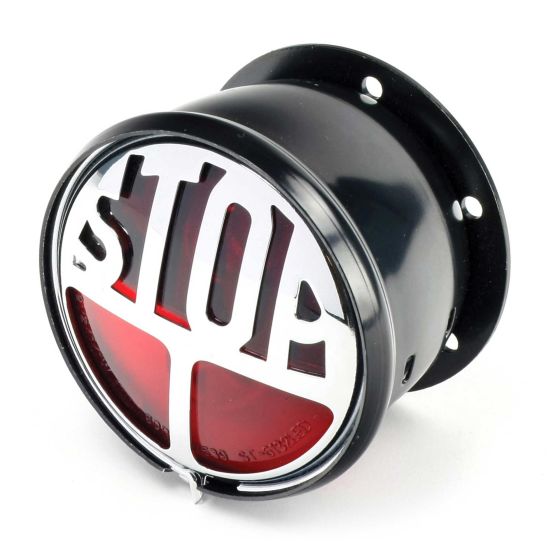 Classic round rear light featuring a black metal casing, chrome accents, and a red lens with the word "STOP" prominently displayed.