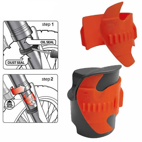 Orange and black plastic fork seal saver scraper designed to clean motorcycle fork seals, featuring grooves for effective dust and oil seal maintenance.