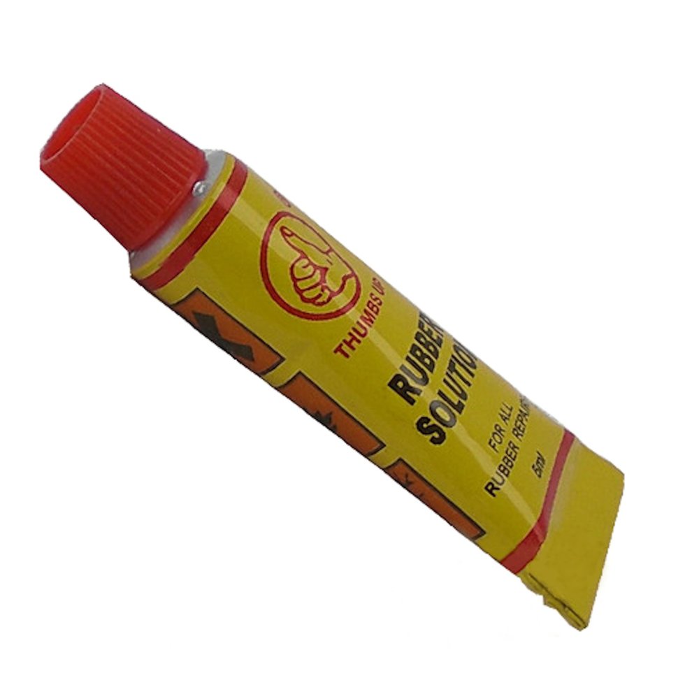 Yellow and red tube of "Thumbs Up" rubber adhesive, labeled "Rubber Solution" for motorcycle handlebar grips, containing 5ml of glue.