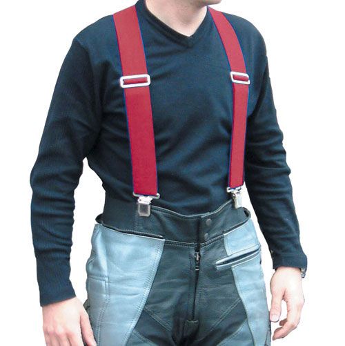 Red adjustable trousers braces with metal clips, worn over a black long-sleeve shirt, paired with grey leather trousers featuring zippered pockets.