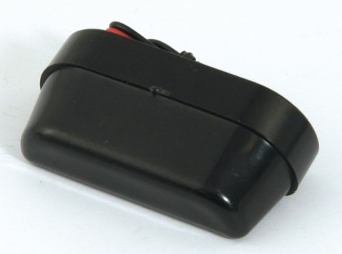 Black solar-powered LED number plate light with a sleek, compact design, featuring a smooth plastic exterior and wiring for installation.