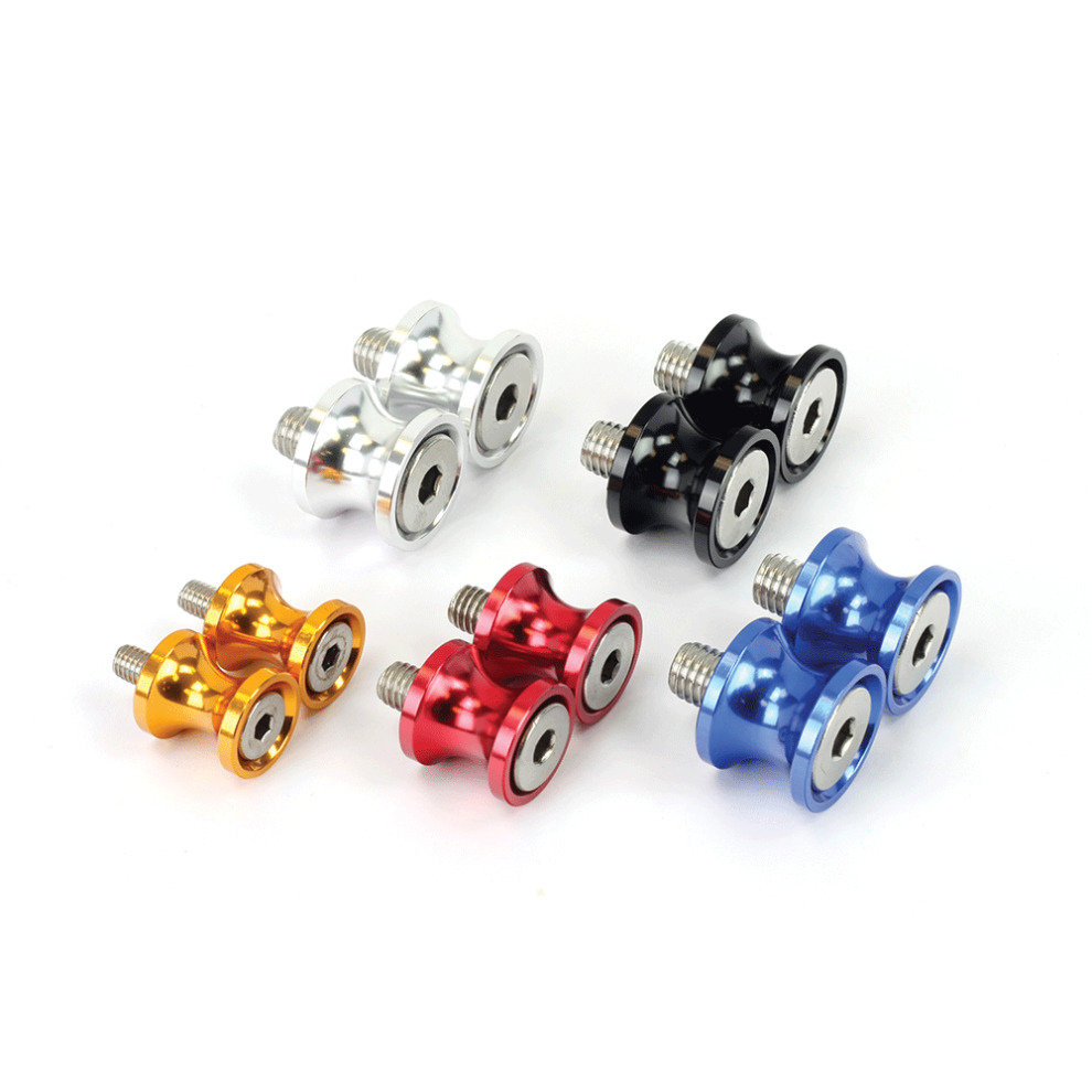 Red motorcycle paddock stand bobbins made of aluminum, featuring a smooth finish and a central hole for easy installation, alongside spools in silver, blue, black, and orange.