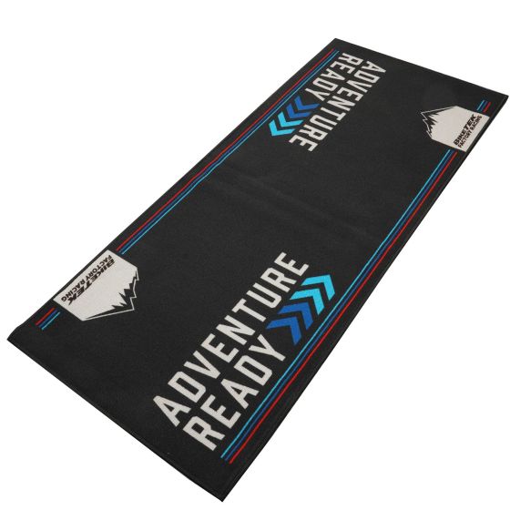 Black environmental carpet featuring "ADVENTURE READY" text in white and blue, with mountain graphics and a sleek, durable design suitable for outdoor activities.