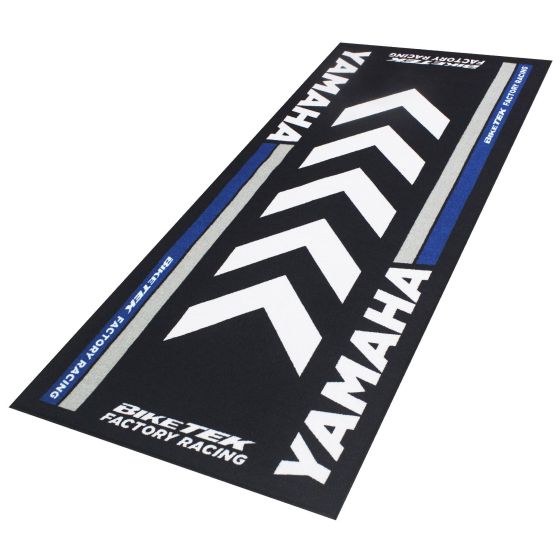 Black carpet featuring bold white and blue chevron patterns, prominently displaying "YAMAHA" and "BIKETEK FACTORY RACING," designed for motorcycle enthusiasts.