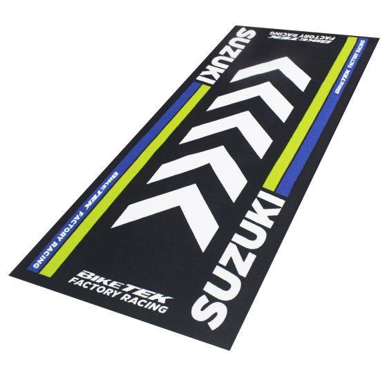 Black garage mat featuring bold white and blue Suzuki branding, with green accents and a chevron design, measuring 190 x 80 cm, made for bike maintenance.