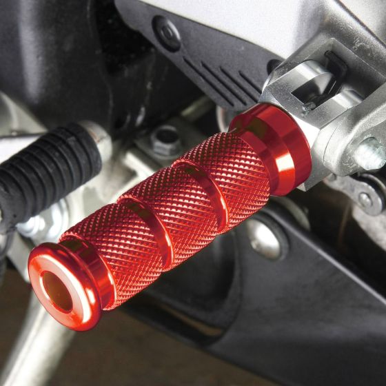 Red alloy round sports front footpeg with a textured grip, designed for Honda motorcycles, featuring a sleek, metallic finish and a secure mounting mechanism.