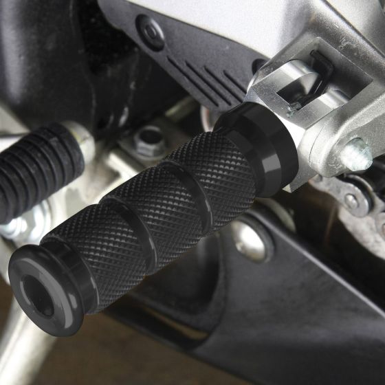 Black alloy round sports footpegs with a textured grip for Kawasaki motorcycles, featuring a sleek design and durable construction for enhanced rider stability.