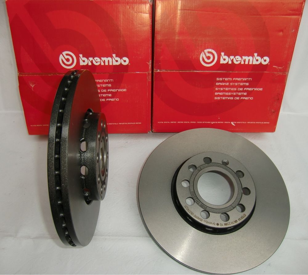 BREMBO brake disc in grey metal, internally vented design, featuring drilled holes for ventilation, accompanied by red packaging with the Brembo logo.