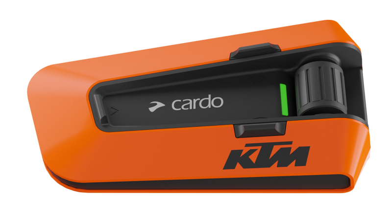 Orange and black Cardo Packtalk Edge communication system featuring a sleek design, a prominent KTM logo, and a user-friendly control knob.