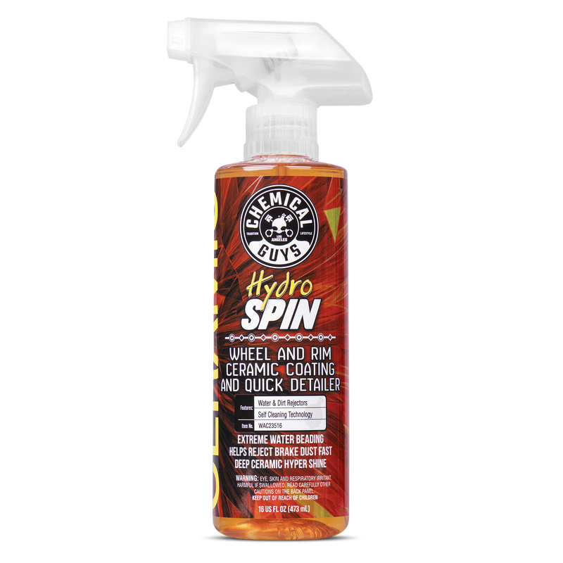 Clear spray bottle with a white trigger, filled with orange liquid, labeled "Hydro Spin" by Chemical Guys, featuring details about ceramic coating and quick detailing for wheels and rims.
