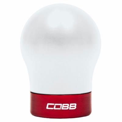 White spherical shift knob with a glossy finish, featuring a red aluminum base and "COBB" logo in white, designed for Fiesta, Focus ST, and Focus RS models.