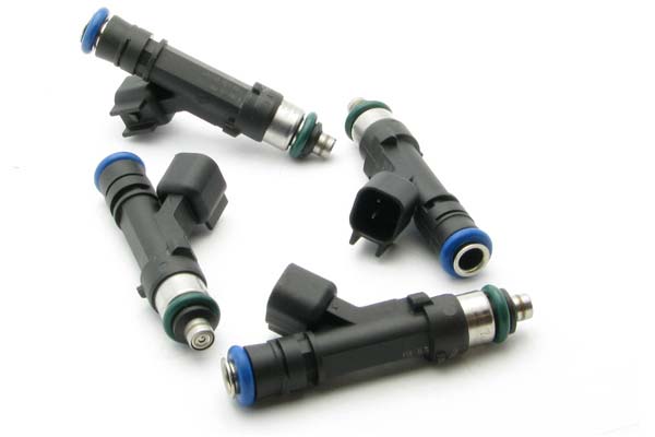 Matched set of four black fuel injectors with green and blue O-rings, featuring metal tips and electrical connectors, designed for Miata by DeatschWerks.