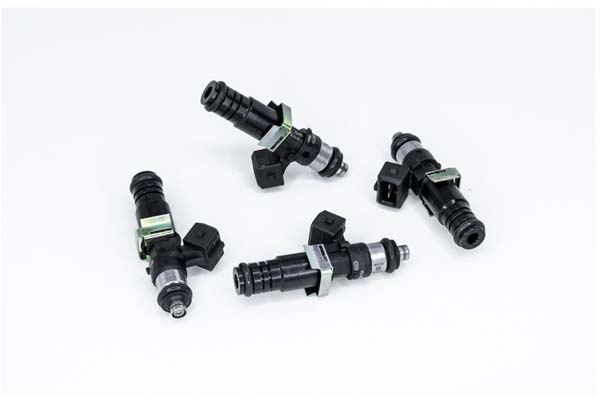 Four black fuel injectors with green clips and silver tips, each measuring 60mm long, labeled as DeatschWerks 1500cc, designed for universal compatibility.