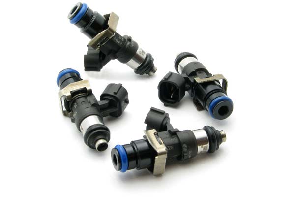 Four fuel injectors with black and silver metal bodies, featuring blue O-rings and connectors, designed for high-performance applications, labeled as DeatschWerks 2200cc.