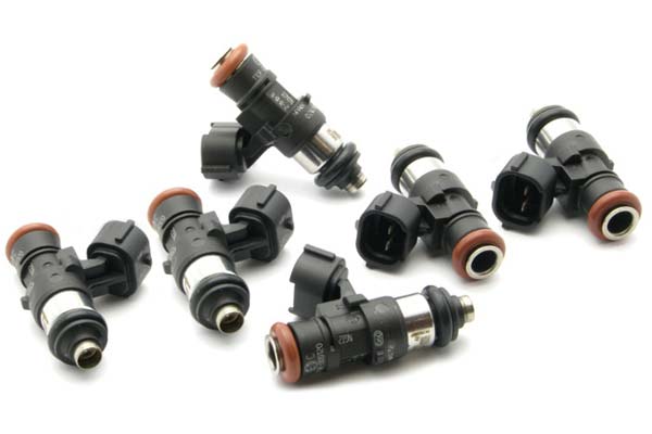 Six DeatschWerks fuel injectors in black and silver with orange seals, featuring a 40mm/14mm size and 2200cc capacity, arranged in a scattered layout.