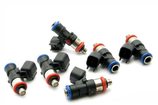 Six fuel injectors in black plastic with red and blue accents, featuring metal tips and electrical connectors, designed for DeatschWerks 440cc applications in Mustang and Wrangler V6 engines.