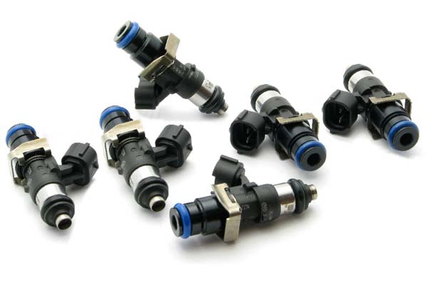 Black and silver fuel injectors with blue o-rings and metal clips, designed for Ford and Volkswagen vehicles, arranged in a group on a white background.