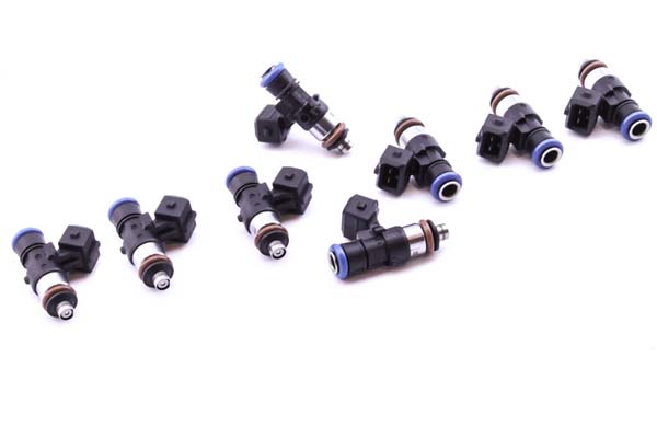 DeatschWerks 1500cc fuel injectors in black and blue, featuring a long 40mm design with rubber O-rings and electrical connectors, arranged in a group on a white background.