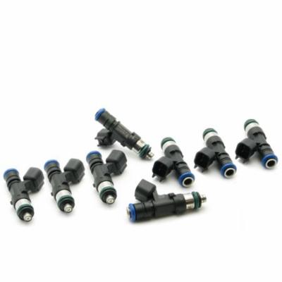 Black and silver fuel injectors with blue O-rings, featuring electrical connectors, designed for Dodge, Ford, and Ram vehicles, arranged in a group.
