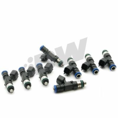 Black fuel injectors with blue and green accents, featuring a cylindrical design and electrical connectors, arranged in two groups on a white background.
