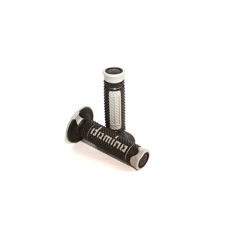 Black rubber off-road grips with a full diamond pattern, featuring gray end caps and white "Domino" branding along the side for enhanced grip and control.