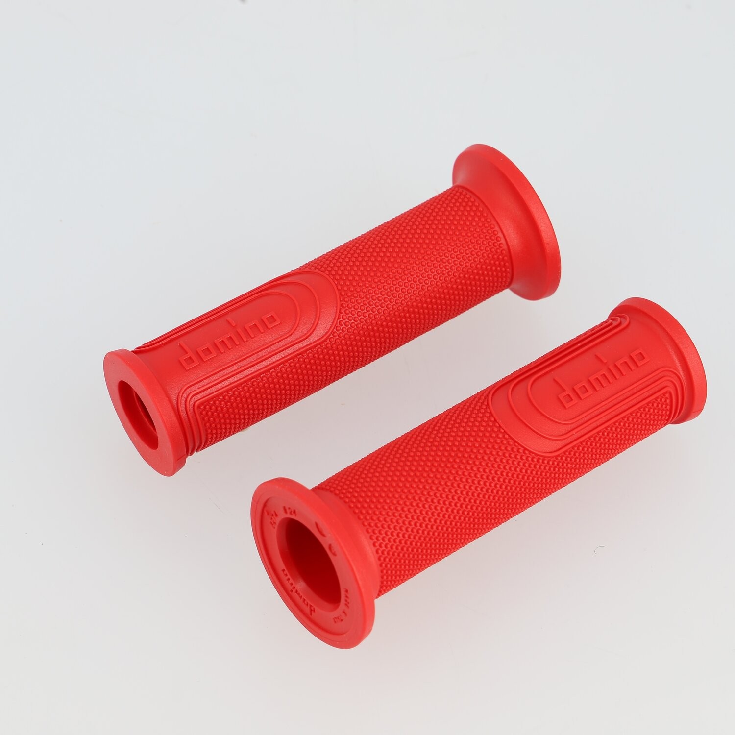 Red rubber grips with a full diamond texture and open style ends, featuring the "Domino" logo embossed on the side.