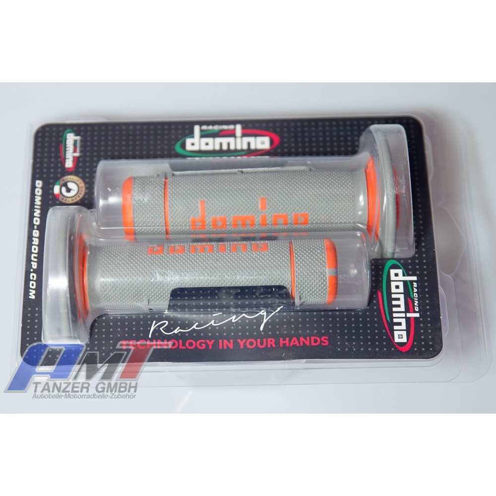 Two-tone gray and orange rubber grips with a full diamond texture, featuring the "Domino" logo, packaged in clear plastic with a black backing.