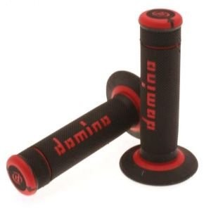 Black rubber grips with full diamond texture, featuring red accents and the "Domino" logo, designed for off-road use.