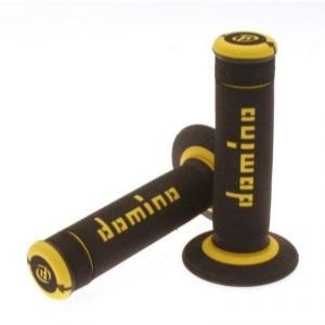 Black rubber grips with full diamond texture, featuring yellow accents and the "Domino" logo, designed for off-road use.