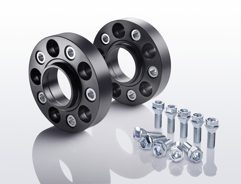 Black aluminum track widening spacers with five holes each, accompanied by silver bolts and nuts, designed to increase track width by 50mm per axle.