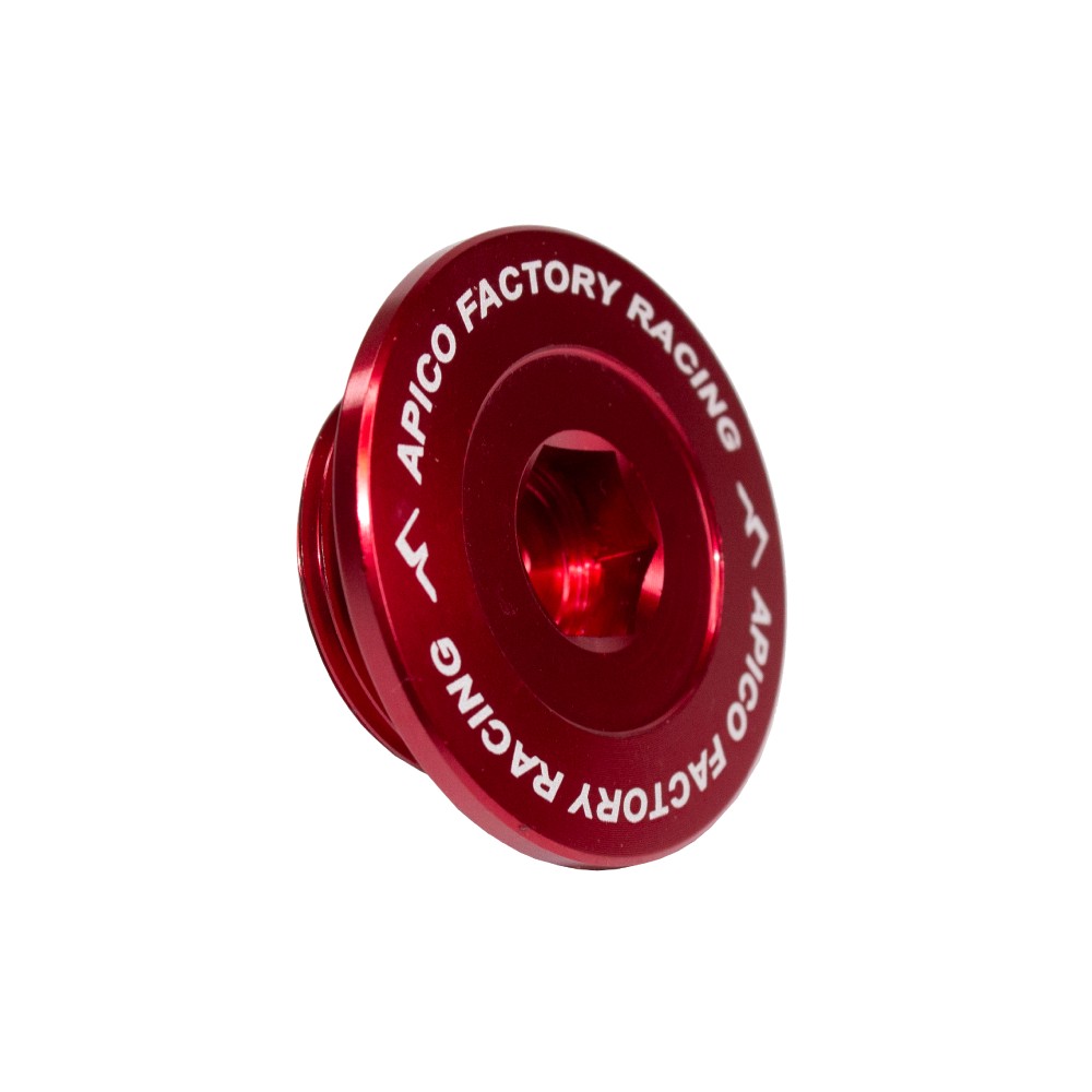 Red anodized aluminum engine plug with "APICO FACTORY RACING" engraved, designed for KTM/Husqvarna SXF/FC and Gas Gas MC 250/450F models from 2011 to 2023.