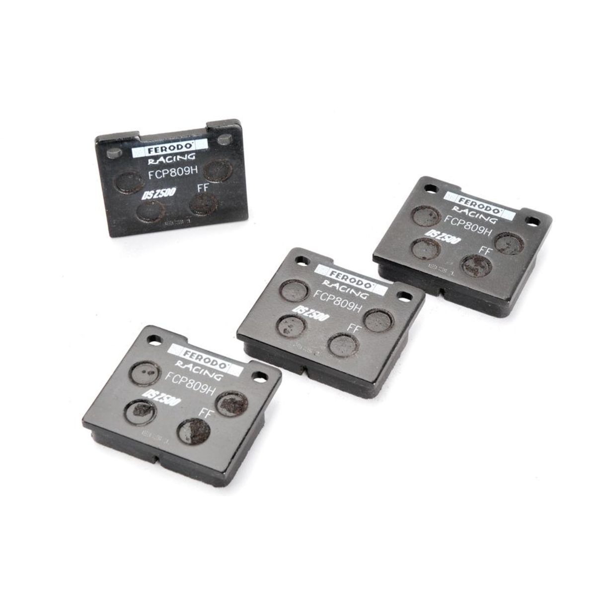 Black brake pad set featuring four pads, labeled "FERODO RACING FCP809H" and "DS2500," with a smooth surface and circular cutouts for enhanced braking performance.