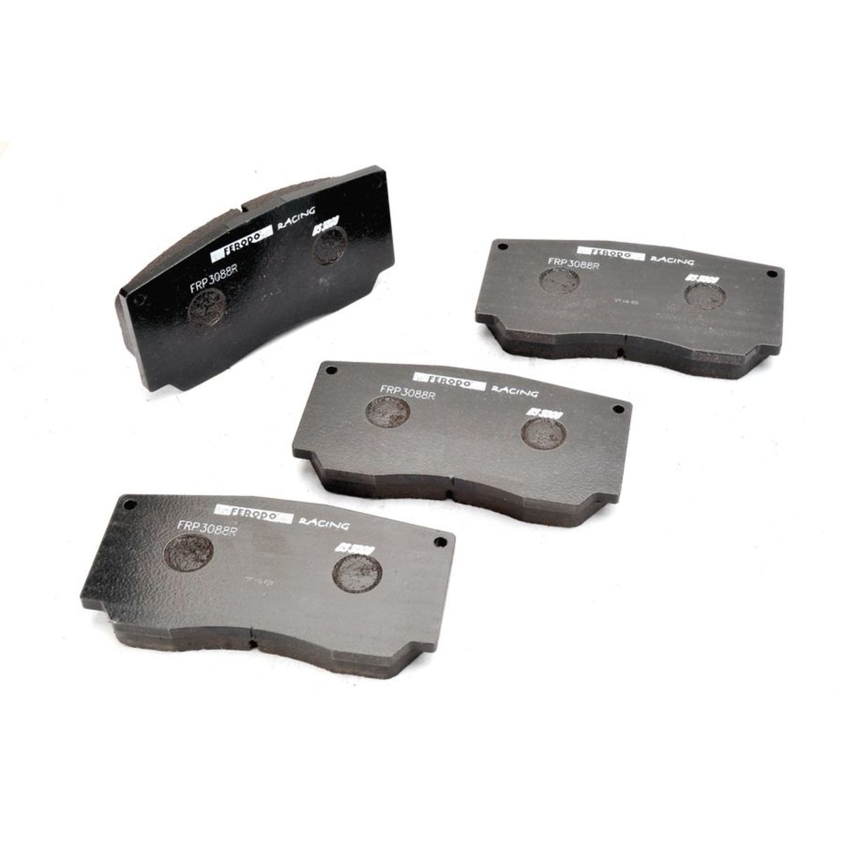 Black Ferodo DS3000 brake pads, set of four, featuring a smooth surface with engraved branding and circular mounting points for easy installation.