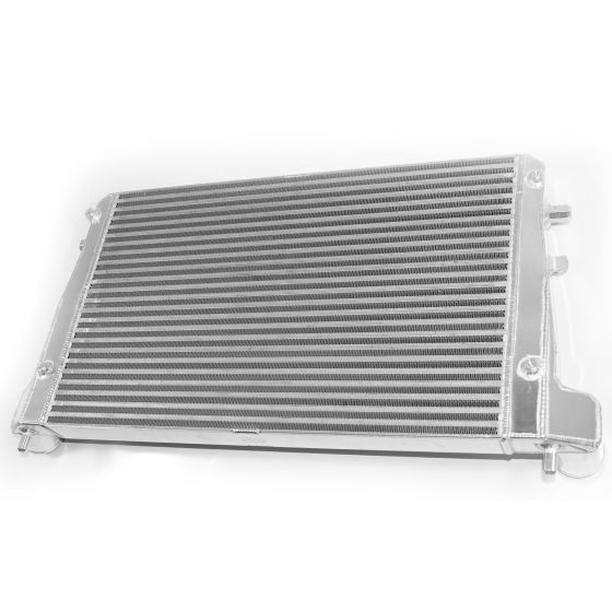 Front mount intercooler featuring a polished aluminum core with horizontal fins, accompanied by vibrant red silicone hoses for enhanced performance.