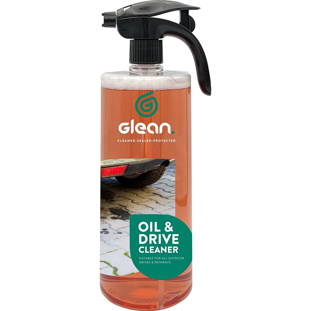 Clear plastic spray bottle containing pink liquid cleaner labeled "GLEAN Oil & Drive Cleaner," designed for removing tough oil stains from driveways and patios, with a black trigger sprayer.