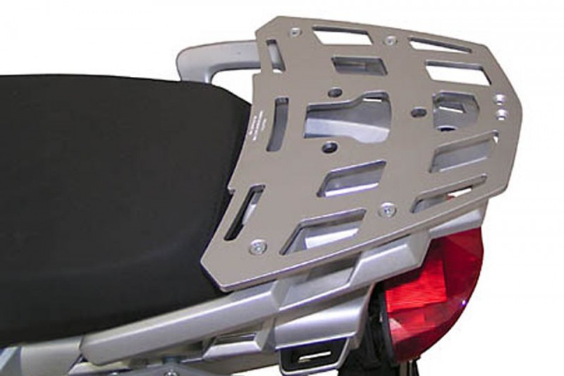 Silver aluminum ALU-RACK for BMW R 1200 GS (04-12) featuring a sturdy, perforated design with multiple mounting points, installed on a motorcycle seat.
