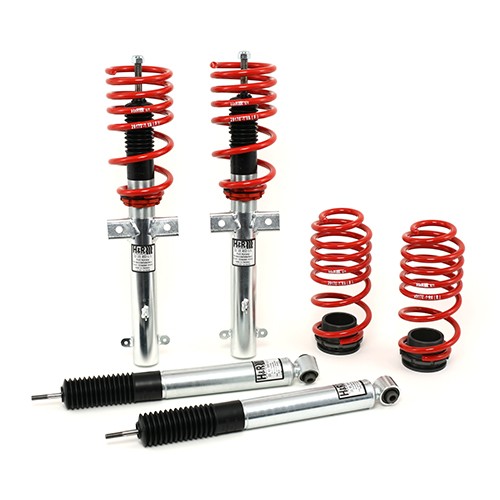 H&R 29512-1 suspension kit featuring red coil springs, monotube shock absorbers with silver metallic bodies, and black rubber mounts for enhanced vehicle performance.