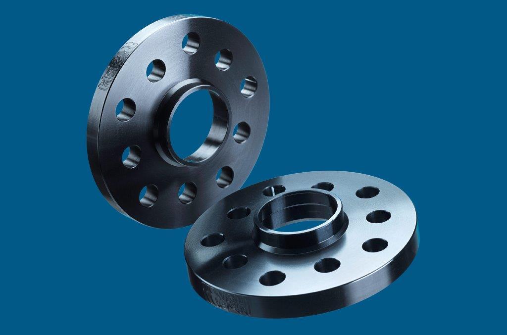 Black aluminum H&R B2055668 Track Widening TRAK+ยฎ wheel spacers, 10mm thick, featuring 5 holes and a central hub, designed for increased track width per axle.