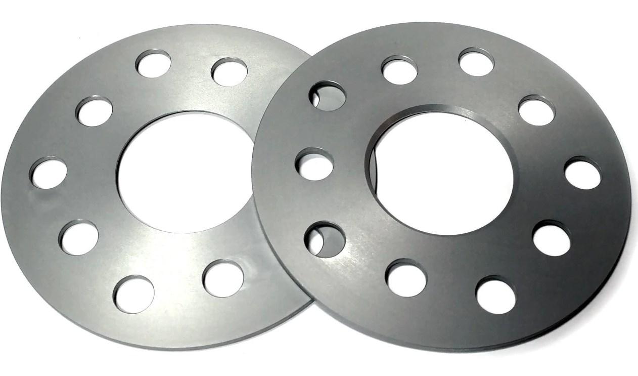 Silver aluminum wheel spacers with a smooth finish, featuring five holes and a central opening, designed for track widening of 6mm per axle.